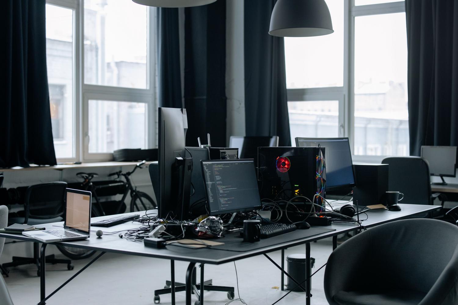Modern technical workspace with multiple monitors and a high-performance PC, representing a system monitoring command center. Modern technical workspace with multiple monitors and a high-performance PC, representing a system monitoring command center.