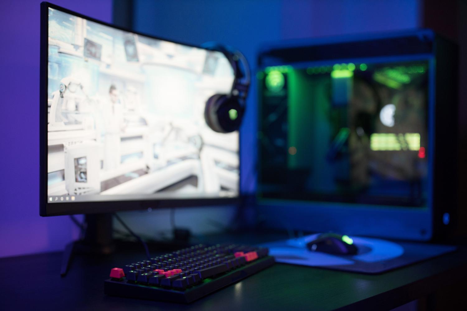 High-tech gaming setup with curved monitor and RGB lighting, ideal for illustrating real-time hardware monitoring during gameplay. High-tech gaming setup with curved monitor and RGB lighting, ideal for illustrating real-time hardware monitoring during gameplay.