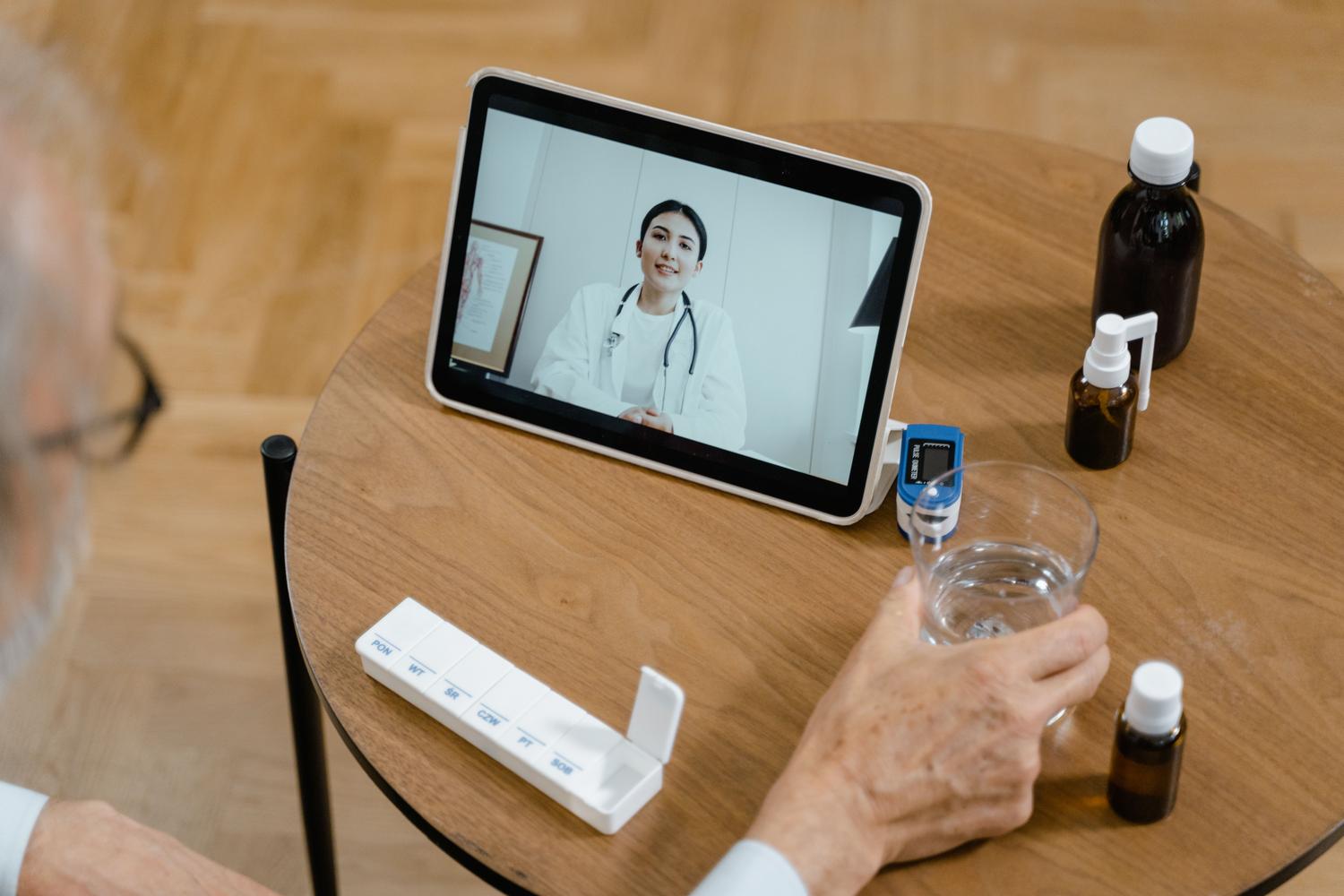 Persona mayor utilizando una tablet para una cita médica virtual, destacando la accesibilidad y el cuidado familiar. Persona mayor utilizando una tablet para una cita médica virtual, destacando la accesibilidad y el cuidado familiar.