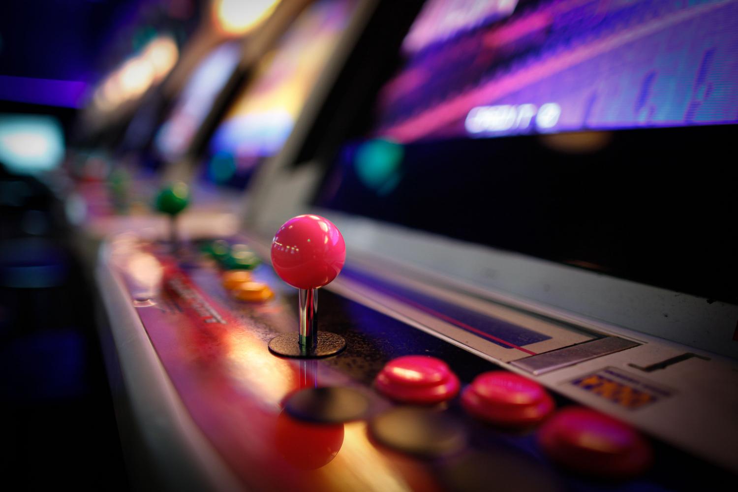 Detailed shot of a vintage arcade machine with neon lights, capturing the atmosphere of classic gaming halls. Detailed shot of a vintage arcade machine with neon lights, capturing the atmosphere of classic gaming halls.